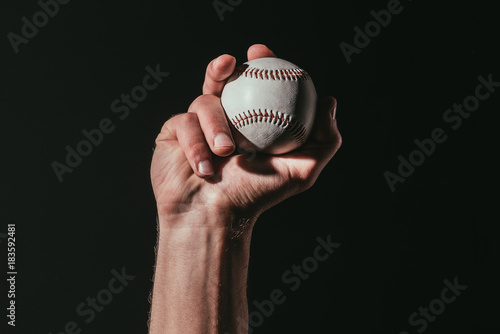 Photography partial view of sportsman holding baseball ball isolated on black
