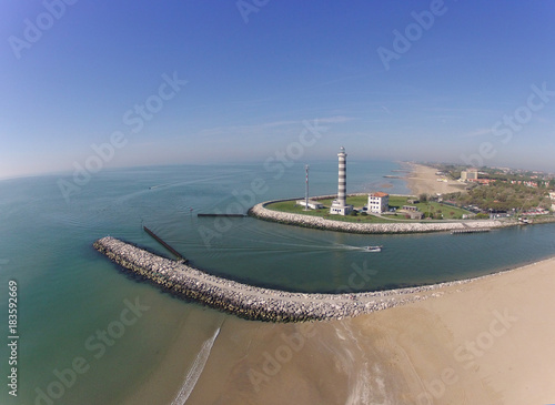Aerial view of lighthouse, beach, sea, river, boat, italy jesolo
