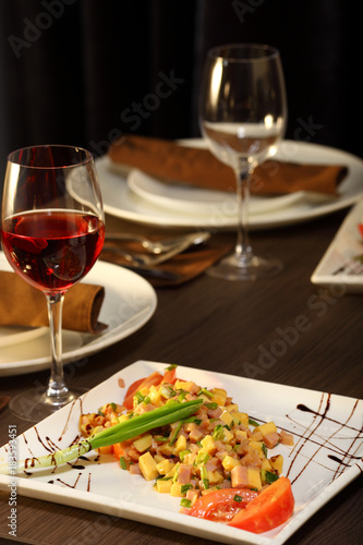 luxury dinner served on the table with glass of red wine