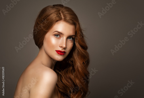 Natural Beauty. Young Redhead Woman with Freckles and Natural Red Curly Hair