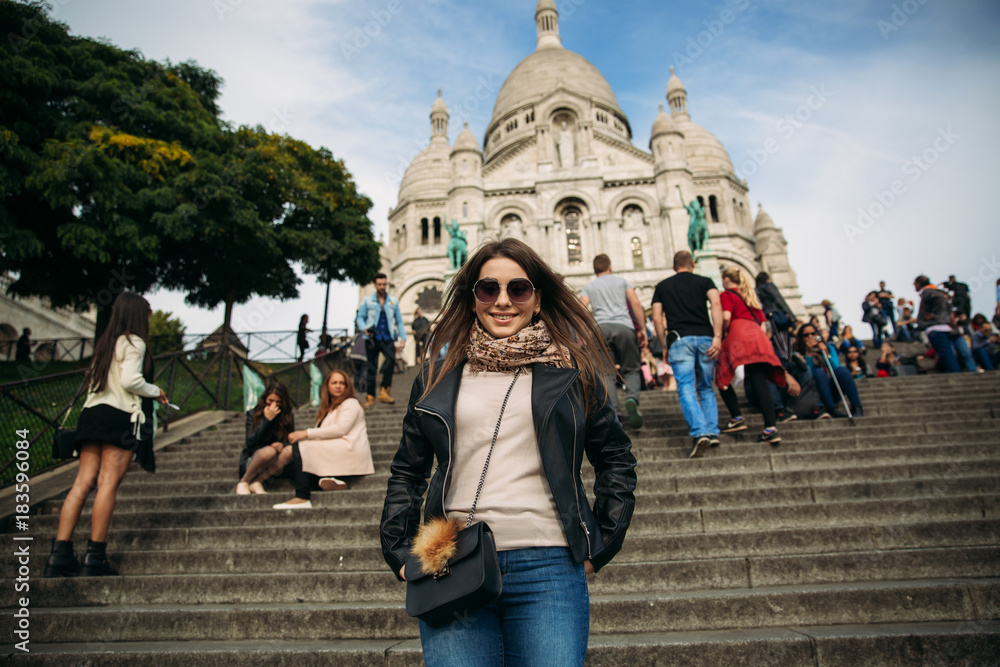 Beautiful girl is walkin in paris near the basilica