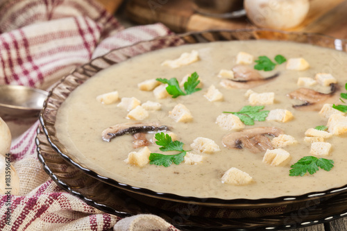 Mushroom cream soup with croutons and spices