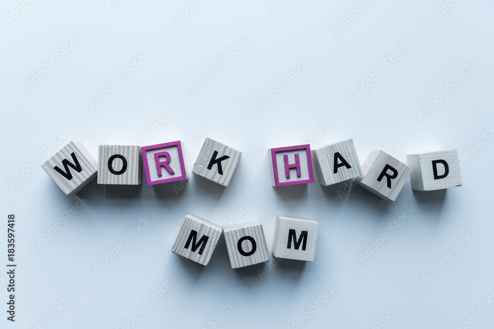 top view of wooden cubes with words Work Hard Mom on blue table top view of wooden cubes with words Work Hard Mom on blue table