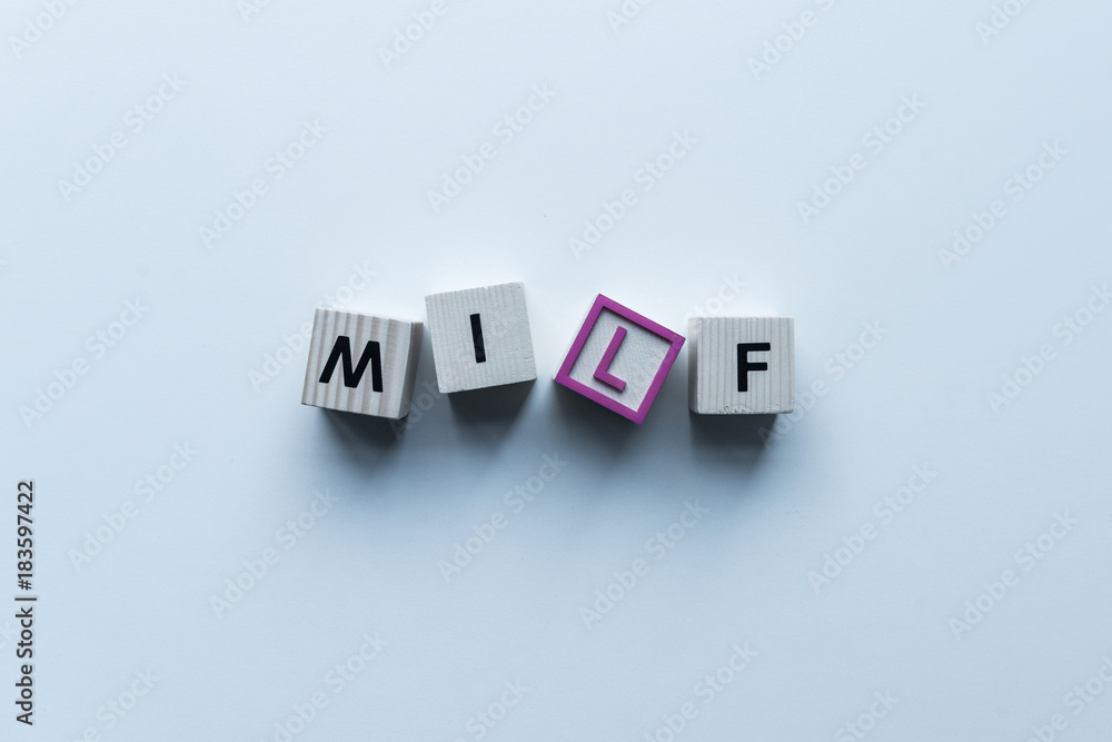 Obraz premium top view of wooden cubes with word Milf on blue tabletop