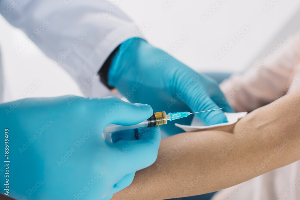 cropped image of doctor taking patient blood for test in medical gloves cropped image of doctor taking patient blood for test in medical gloves