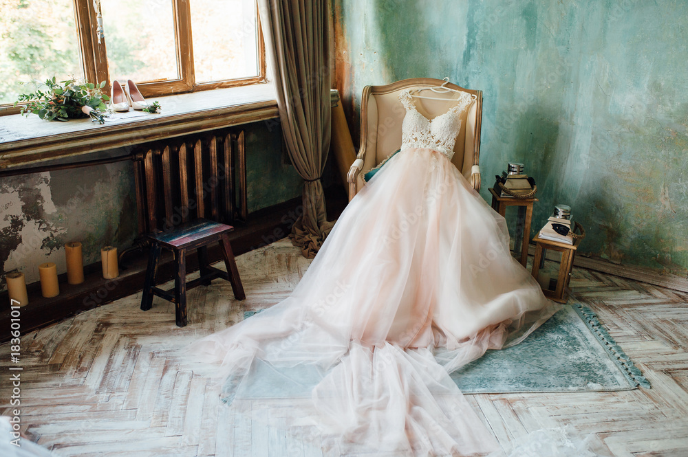 Shoes and wedding dress on chair in room Shoes and wedding dress on chair in room