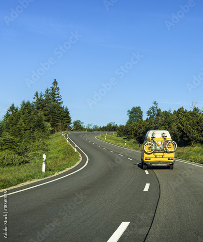 Camper van with Bicycles on a curving country road in the Black Forest Region