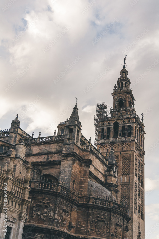 old gothic Seville Cathedral under cloudy sky, spain