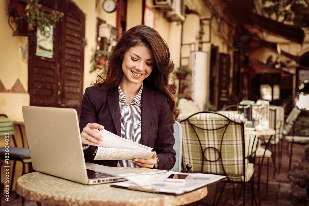 Smiling business woman at cafe. Smiling business woman at cafe.