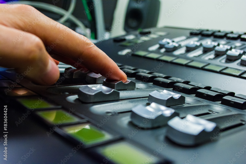 Fototapeta premium hand on a light, mixing desk fader in blur television gallery