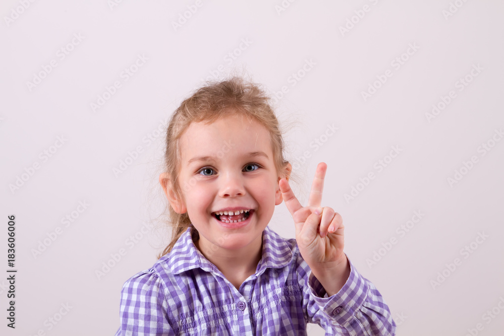 child with a smile shows two fingers child with a smile shows two fingers