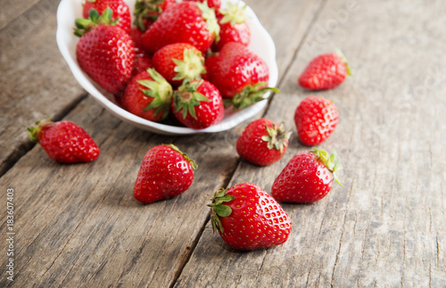 Ripe red strawberries on wooden table