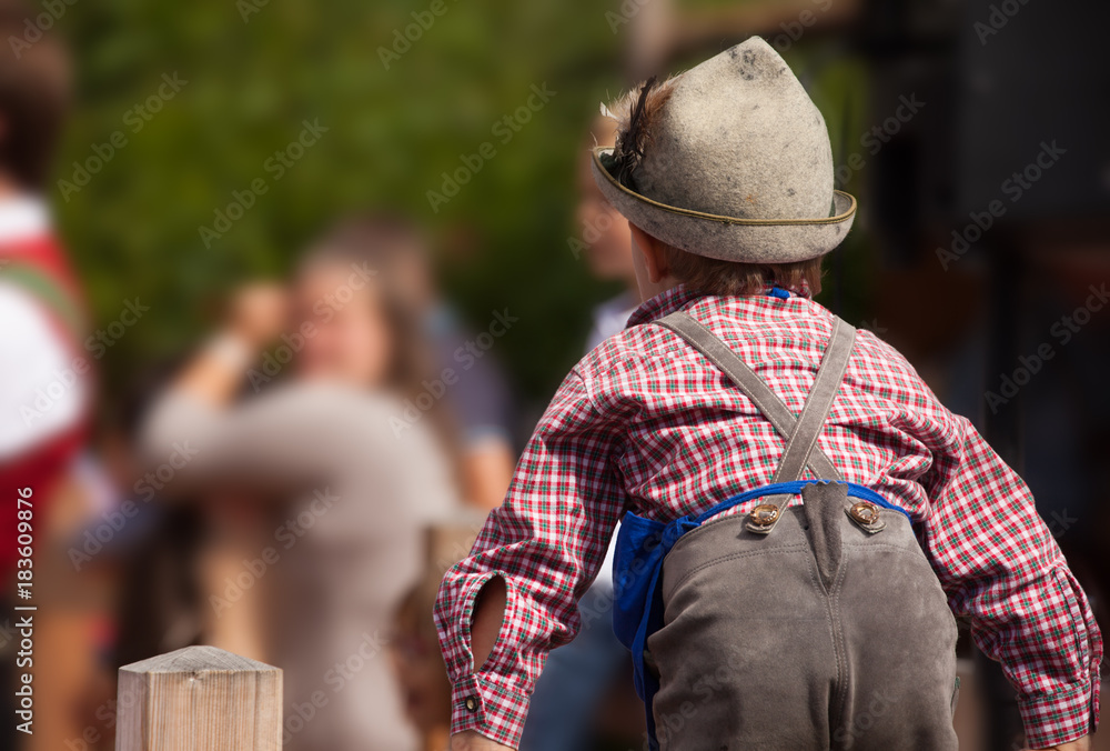 Young child in typical costume during an autumn local celebration in Val di Funes ( South Tyrol )