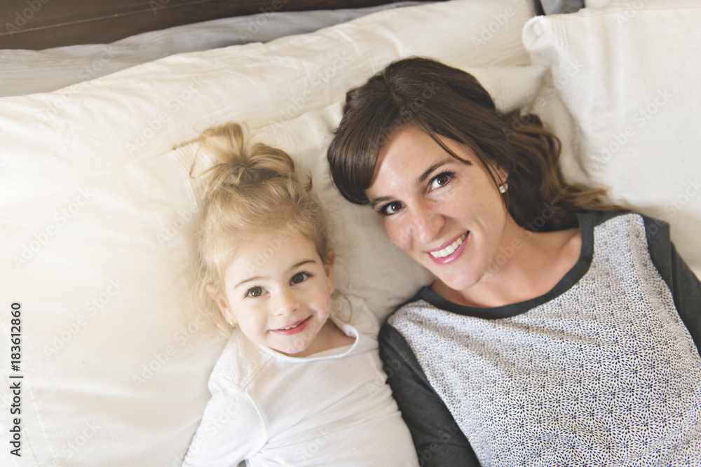 Mother and her daughter child girl taking good time on bed Mother and her daughter child girl taking good time on bed