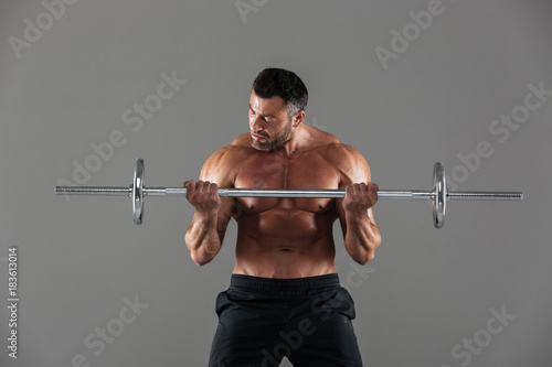 Portrait of a muscular motivated shirtless male bodybuilder