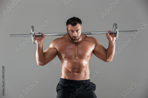Portrait of a concentrated strong shirtless male bodybuilder