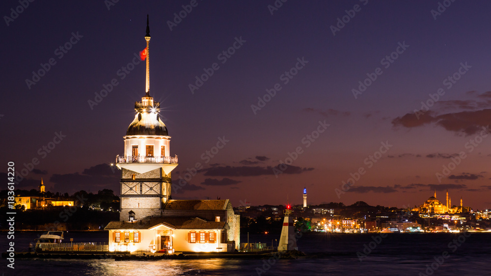 Fototapeta premium Maiden Tower or Kiz Kulesi with floating tourist boats on Bosphorus in Istanbul at night