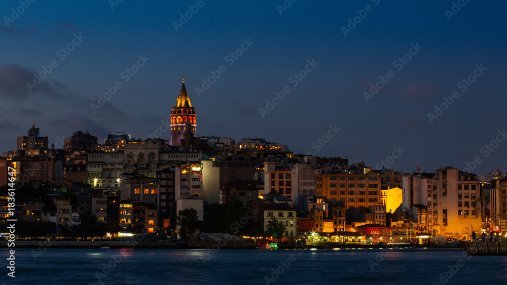 Istanbul cityscape with Galata Tower and floating tourist boats in Bosphorus