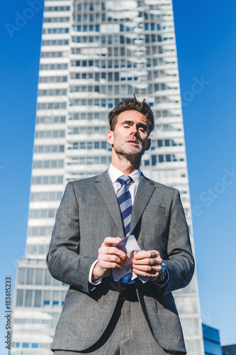 angry businessman rips documents in pieces photo