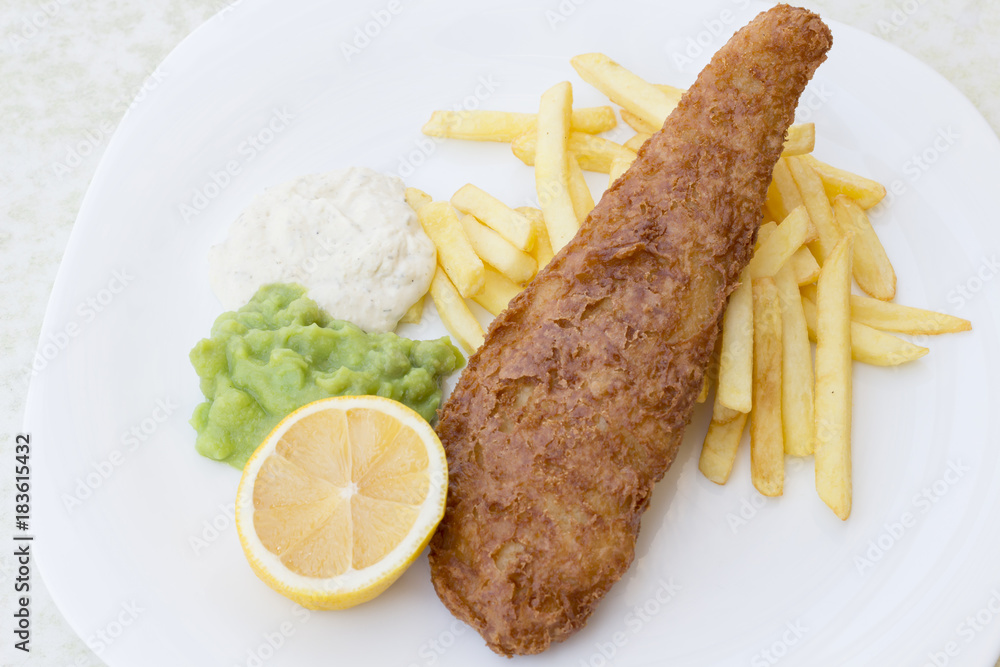British Traditional Fish and chips with mashed peas, tartar sauce on white plate. Top view British Traditional Fish and chips with mashed peas, tartar sauce on white plate. Top view