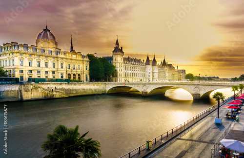 Sunset view of a beautiful bridge and river in Paris city landscape with long exposure photography during summer. The Pont Neuf is the oldest standing bridge across the river Seine in Paris, France.