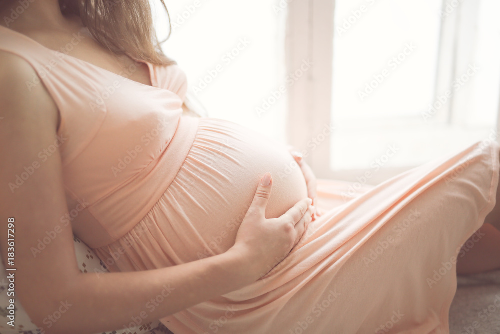 young pregnant woman with long dark hair