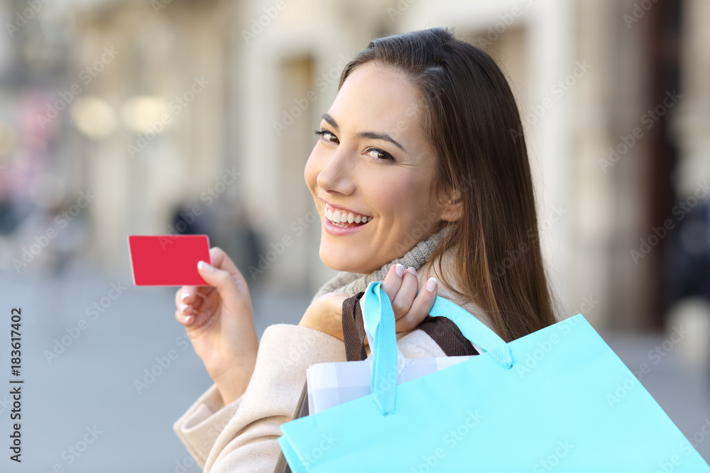 Shopper holding shopping bags and credit card Shopper holding shopping bags and credit card