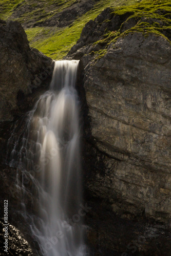 water fall of Altein near Arosa in summer with green meadow
