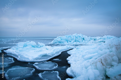 Ice floes floating on the sea surface.