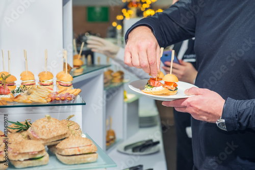 Foto Catering buffet table with food and snacks for guests of the event