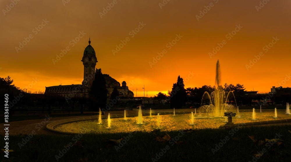 Limoges-Bénédictins sunset view with water pool fountain, railway station, in the Orléans–Montauban railway. Named due to the presence of a Benedictine monastery closed during the France revolution