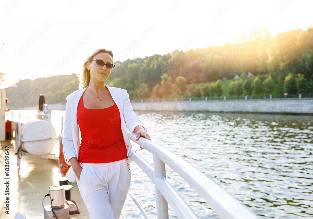 Fototapeta premium Young pretty woman enjoying view on cruise ship deck