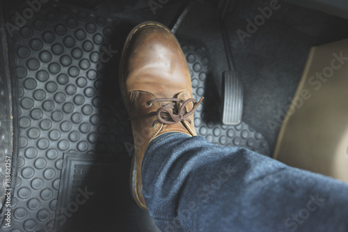 Close up Leather Shoe ob pedal in car photo