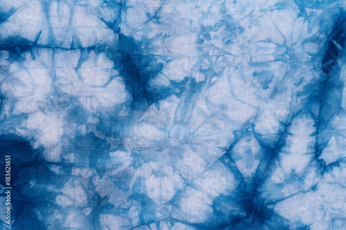 Pattern of blue dye on cotton cloth  Dyed indigo fabric background and textured