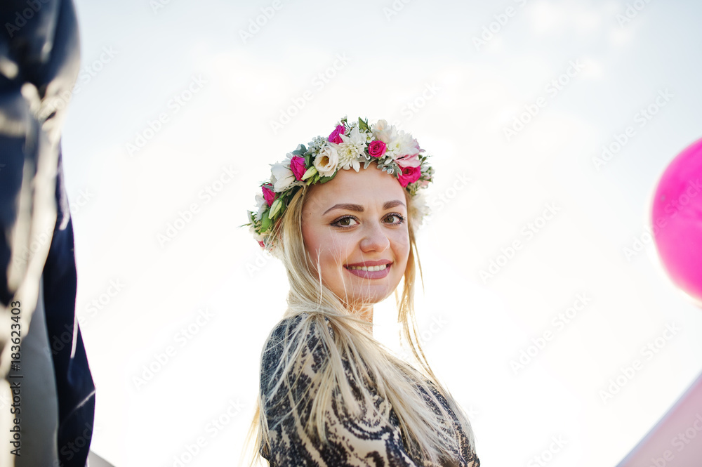 Blonde girl in wreath sitting on yacht at hen party. Blonde girl in wreath sitting on yacht at hen party.