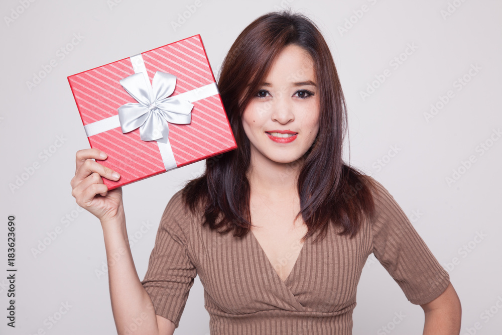 Young Asian woman with a gift box. Young Asian woman with a gift box.