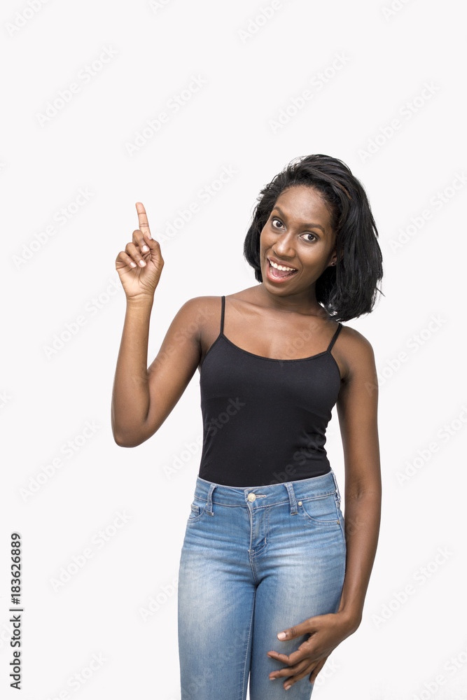 Woman pointing up and looking at camera Woman pointing up and looking at camera