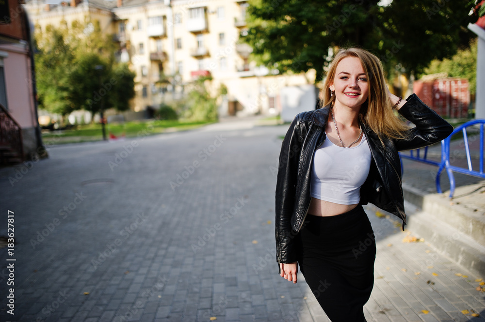 Elegant blonde girl wear on black leather jacket posing at streets of town. Elegant blonde girl wear on black leather jacket posing at streets of town.