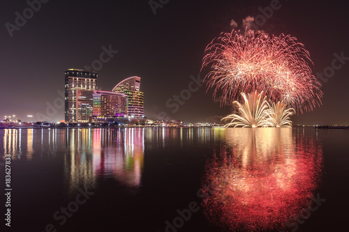 Celebration of UAE National Day with fireworks over the Festival City district. Dubai, UAE.