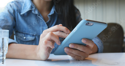 Photography Woman use of smart phone in restaurant