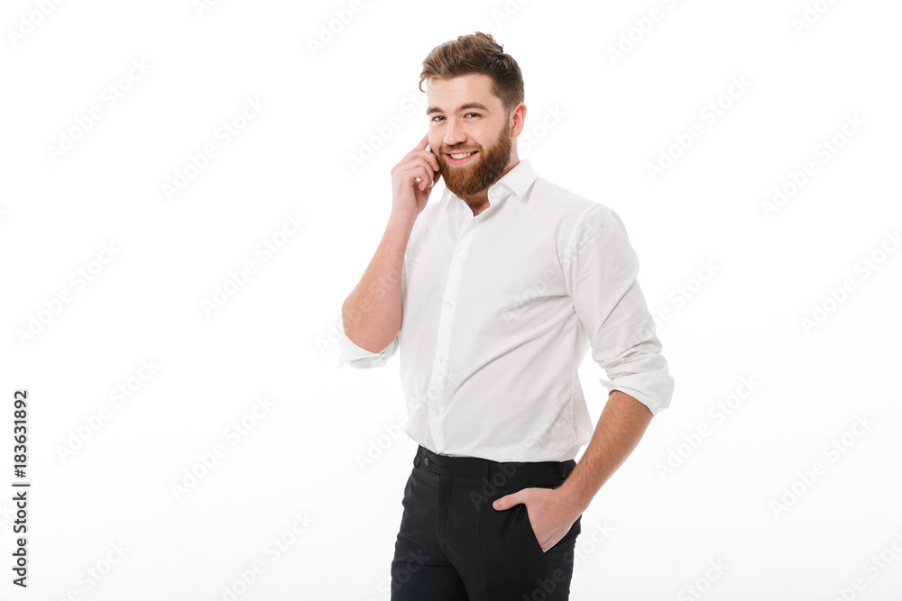 Smiling bearded man in business clothes talking by smartphone Smiling bearded man in business clothes talking by smartphone