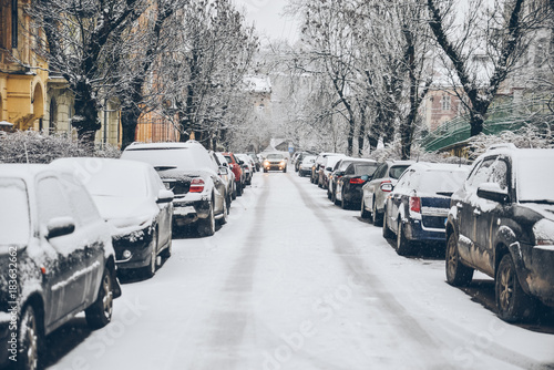 cars covered by snow at the street © phpetrunina14