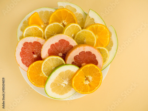 Colorful set of cut slices of citrus fruits of orange  lime  grapefruit  tangerine  lemon and pomelo. Mixed fresh health fruit. Background with citrus-fruit of lemon  orange and grapefruit slices.