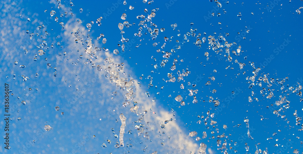 water splashing from the fountain in the background of blue sky