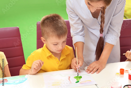 Little boy with teacher at ...