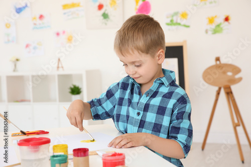 Little boy at painting less...
