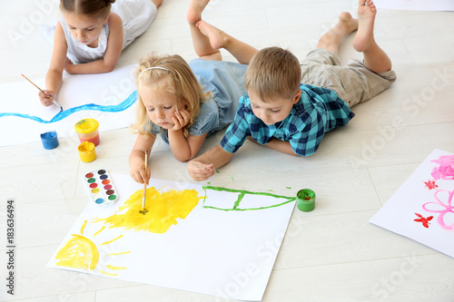 Children lying on floor in ...