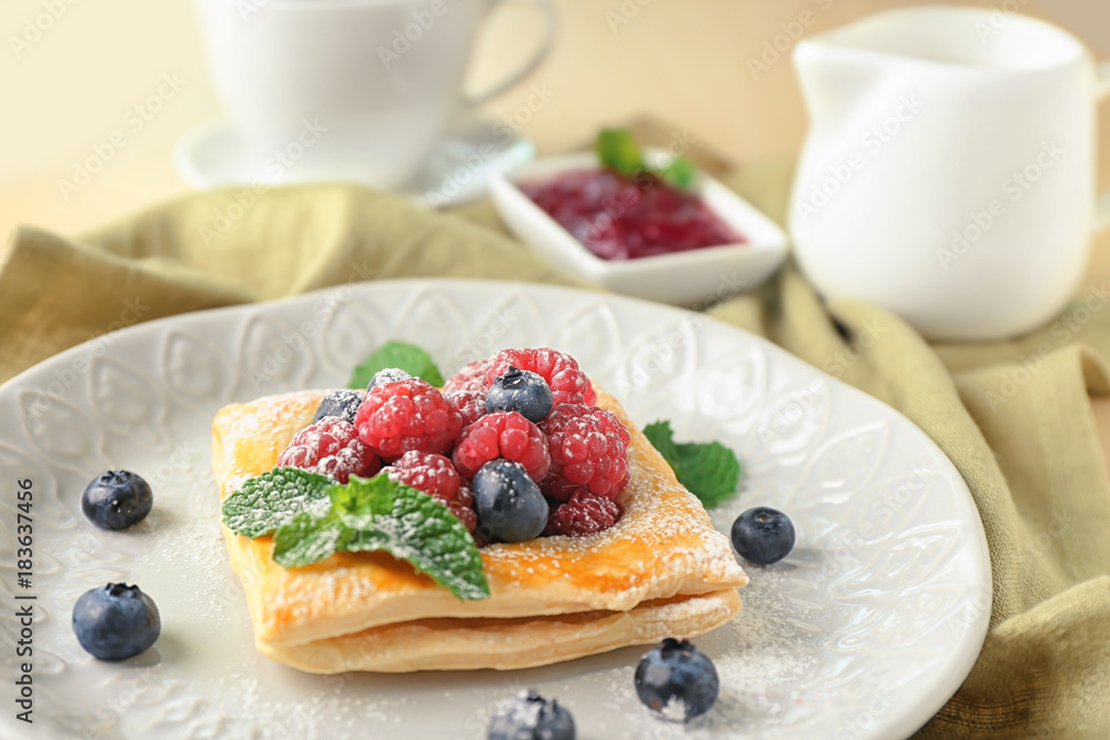 Plate with yummy berry puff pastry on table Plate with yummy berry puff pastry on table