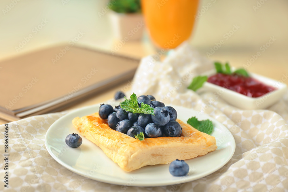 Plate with yummy berry puff pastry on table Plate with yummy berry puff pastry on table