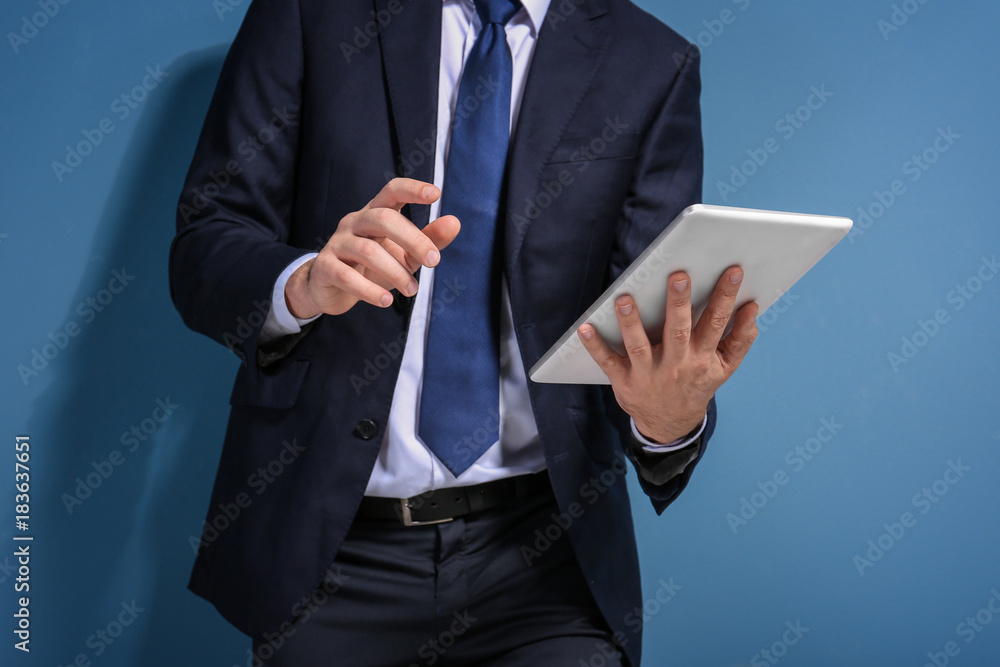 Stock exchange broker with tablet on color background Stock exchange broker with tablet on color background